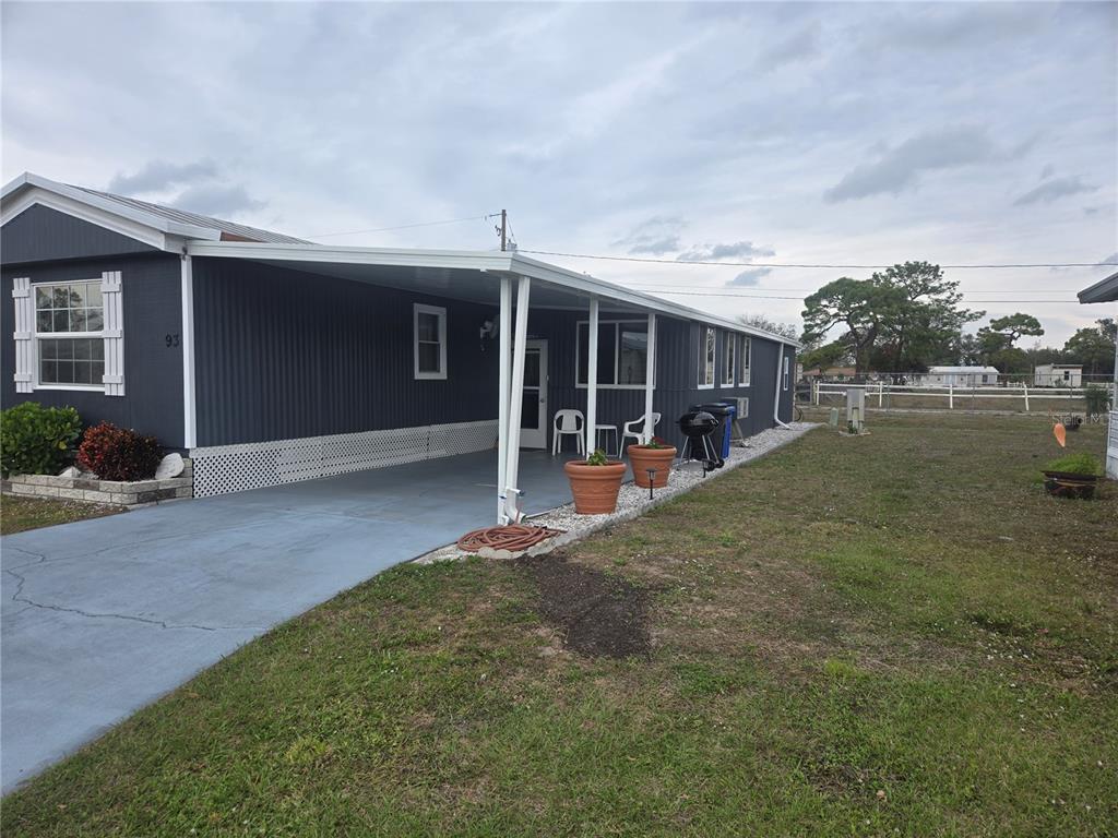 1710 7th Street Southwest, Unit 93 Ruskin, FL 33570 - Photo 38 of 38 a view of a house with backyard and porch