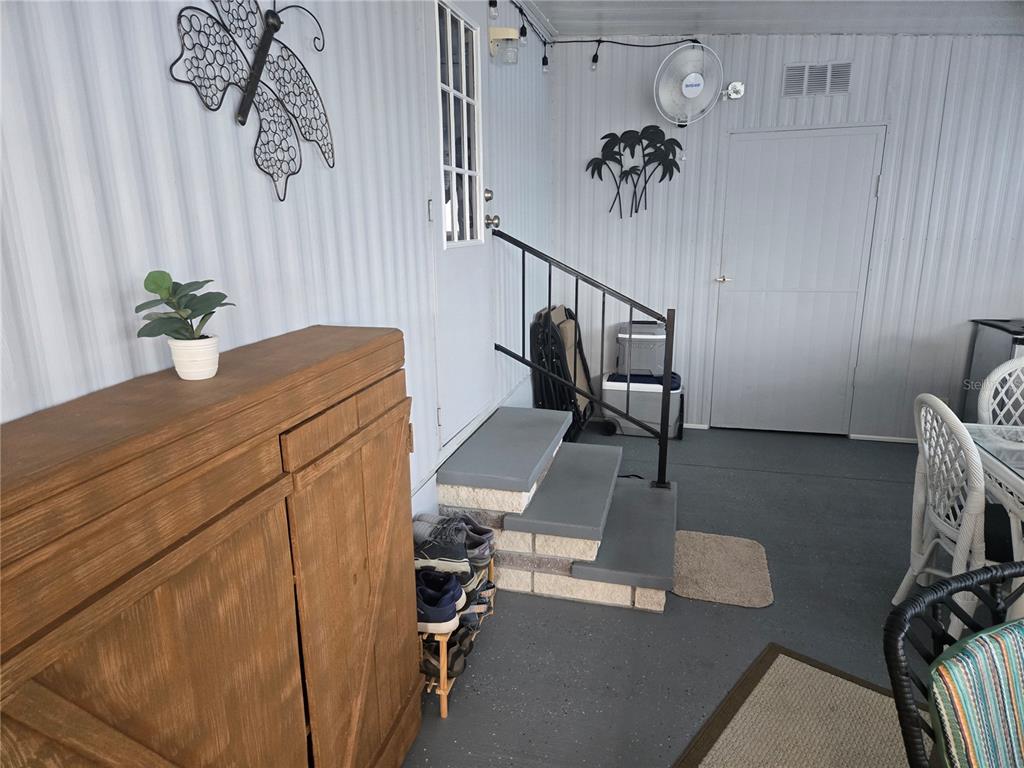 1710 7th Street Southwest, Unit 93 Ruskin, FL 33570 - Photo 5 of 38 a bedroom with a bed and a chandelier