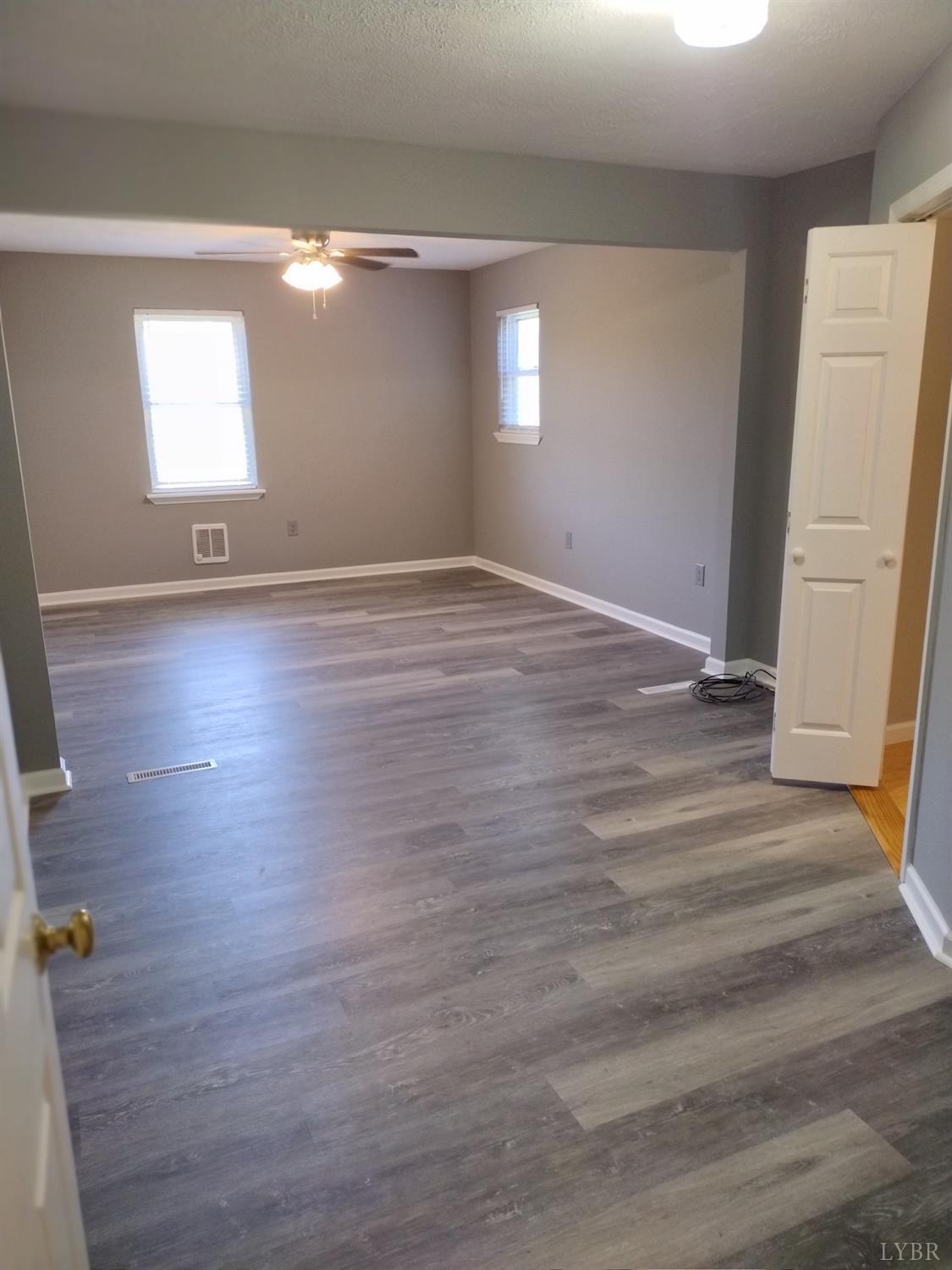 4499 Stage Road Concord, VA 24538 - Photo 21 of 64 an empty room with wooden floor and windows
