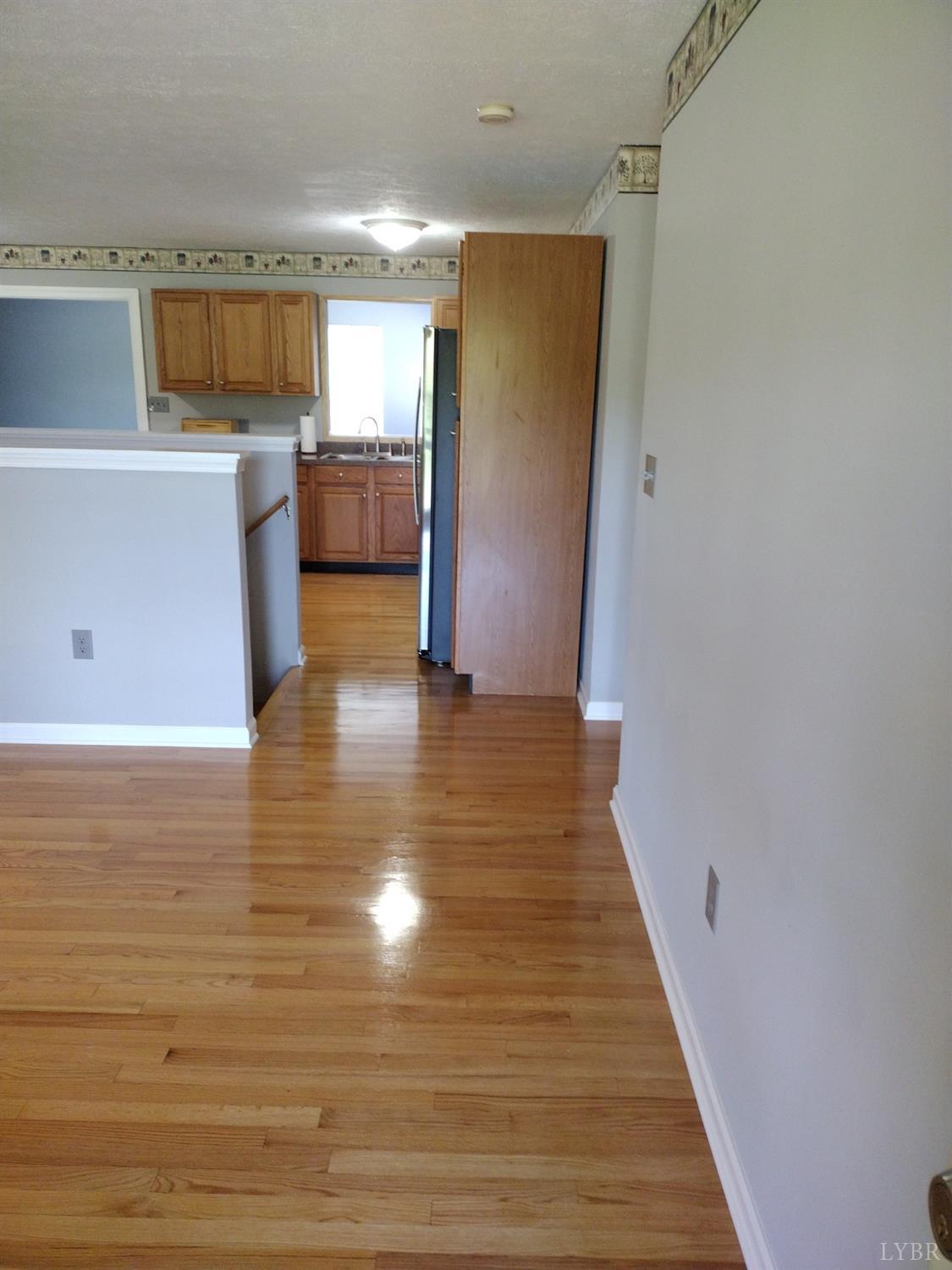 4499 Stage Road Concord, VA 24538 - Photo 8 of 64 a view of a kitchen with a sink stove cabinets and a floor to ceiling window