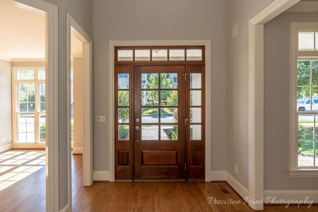 a view of an entryway door with wooden floor