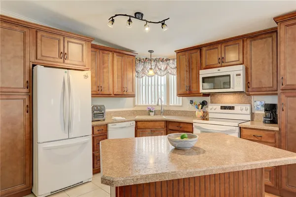 a kitchen with stainless steel appliances granite countertop a refrigerator stove microwave and sink