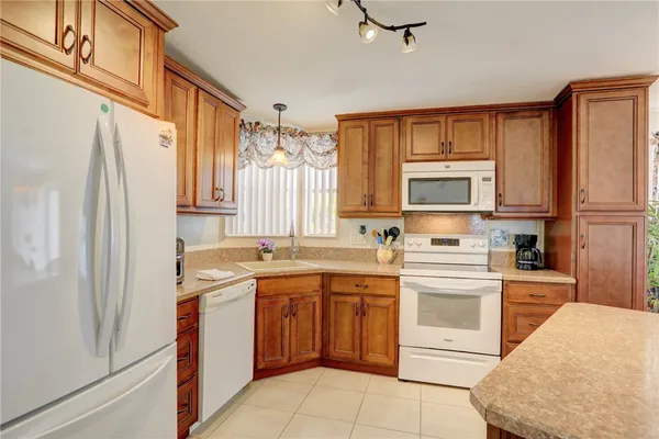 a kitchen with a sink a window and stainless steel appliances