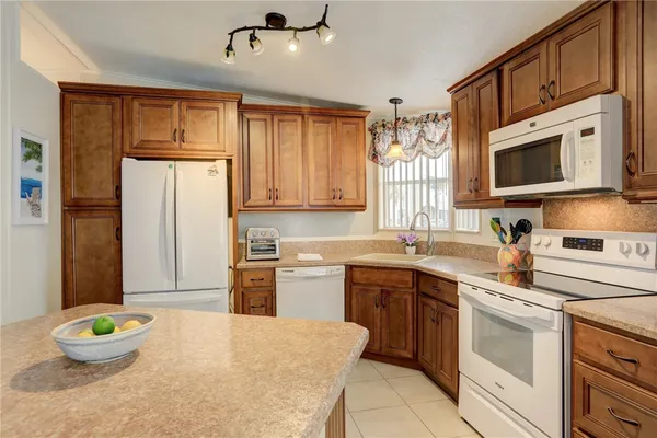 a kitchen with a sink stove and refrigerator