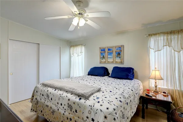 a bedroom with a large bed and a window