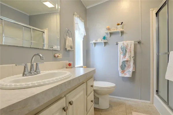 a bathroom with a sink toilet and a mirror