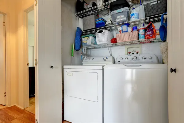 a utility room with dryer washer and closet