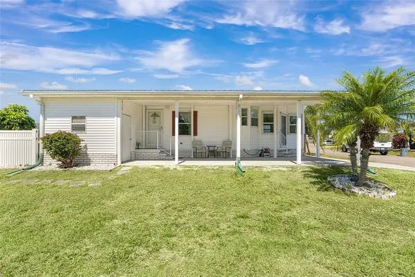 a view of a house with a yard and plants