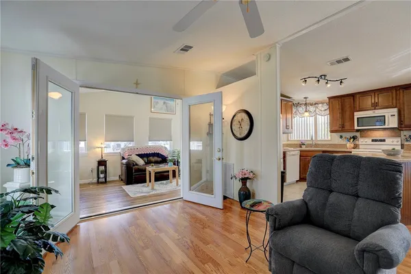 a living room with furniture kitchen view and a fireplace