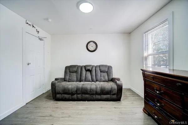 a living room with a couch and a dresser