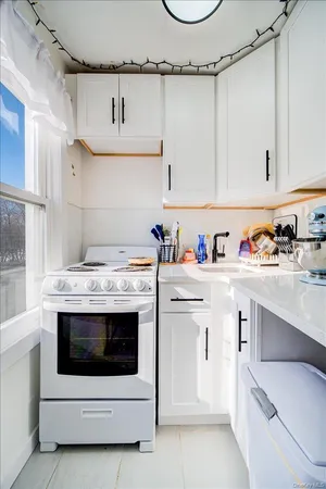 a utility room with cabinets washer and dryer