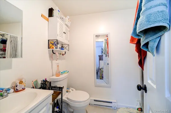 a bathroom with a sink a toilet and a mirror