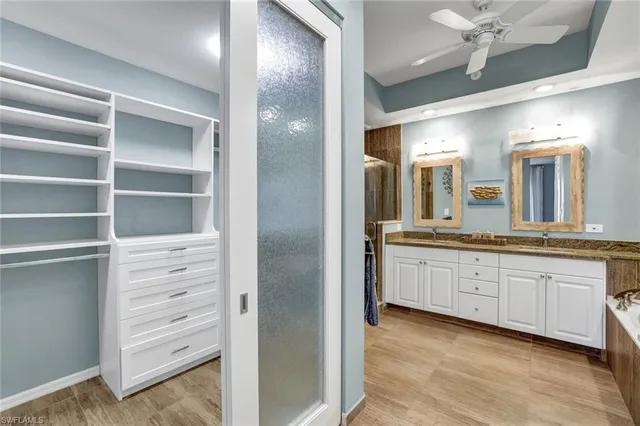 a bathroom with a double vanity sink and a mirror