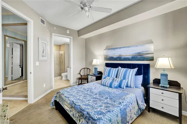 a bathroom with a granite countertop toilet a sink a mirror a shower and a bathtub