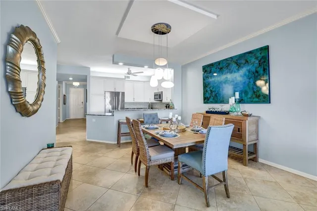a view of a dining room with furniture and chandelier