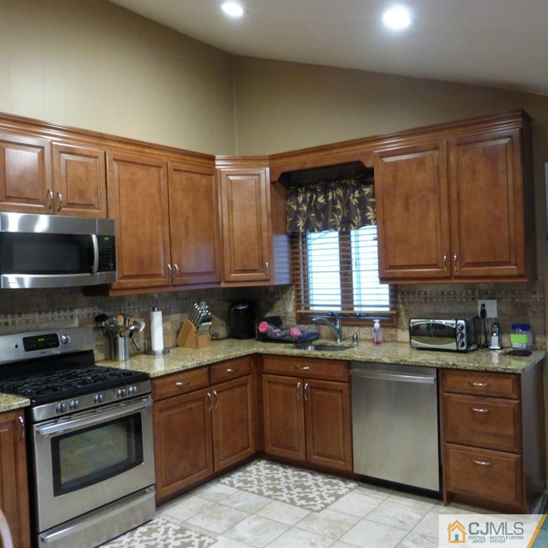 37 Albemarle Road Colonia, NJ 07067 - Photo 3 of 8 a kitchen with a sink stove top oven and cabinets