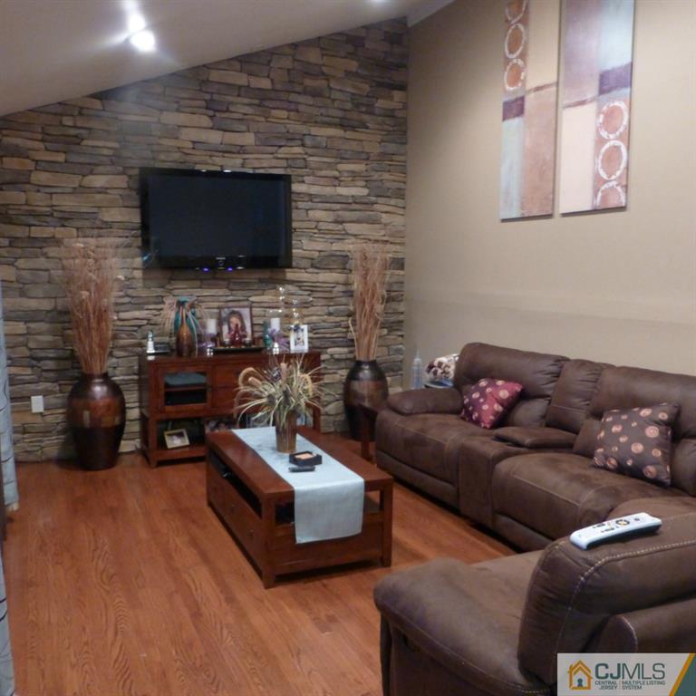 37 Albemarle Road Colonia, NJ 07067 - Photo 4 of 8 a living room with furniture and a flat screen tv