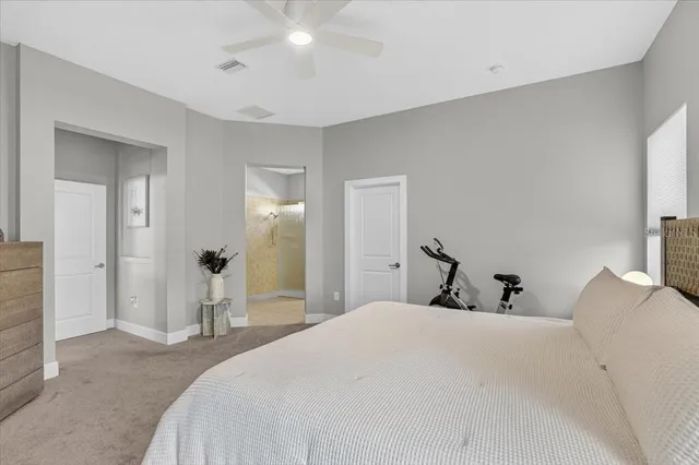 a bedroom with a large bed and a couch