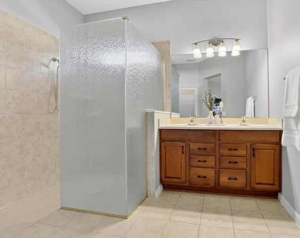 a spacious bedroom with a bed and a chandelier