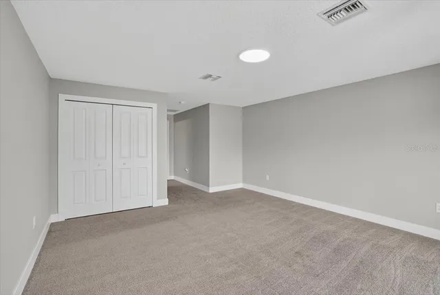 a view of a patio with a table chairs and a lake view