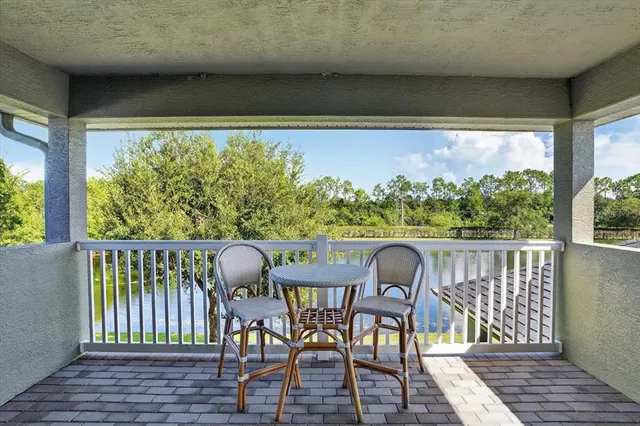 a view of a lake with a big yard and large trees