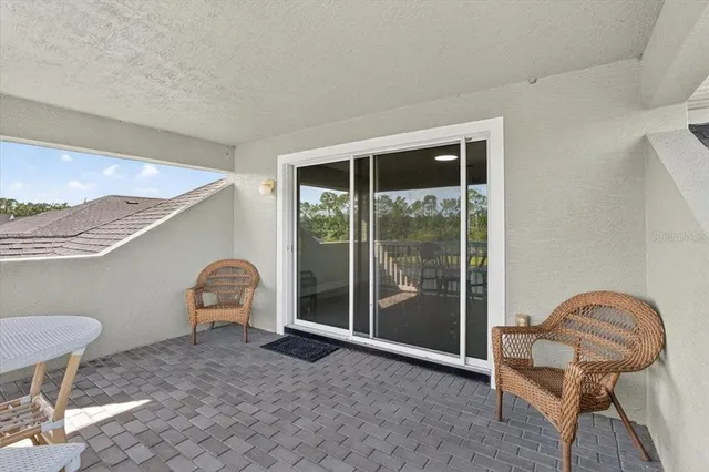 a front view of a house with patio and garden