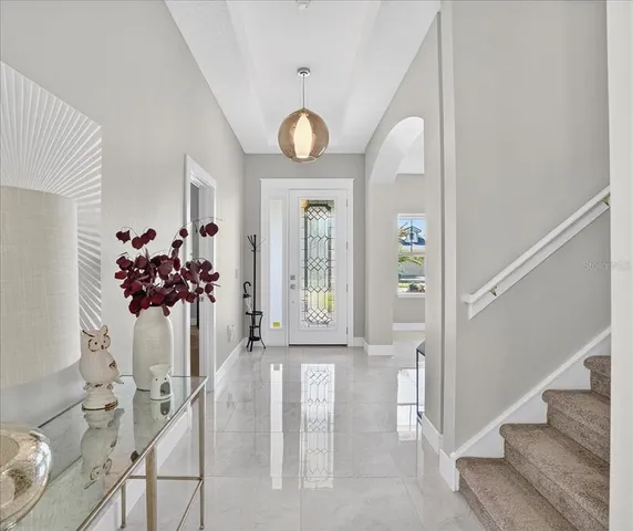 a living room with furniture a flat screen tv and a large window