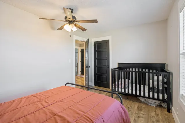 a bedroom with a bed and a chandelier