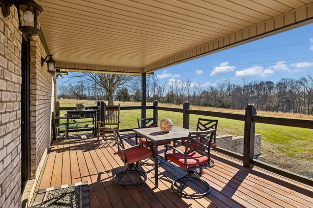 a view of a balcony with lake view and wooden floor