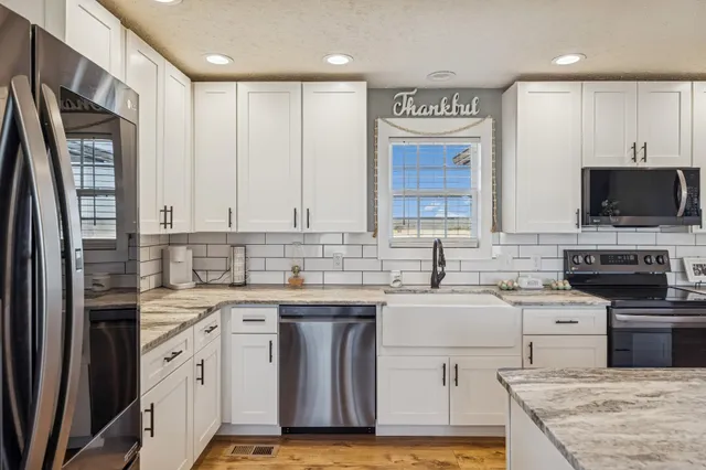a kitchen with a sink stove and refrigerator