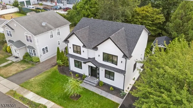 a aerial view of a house with a yard table and chairs