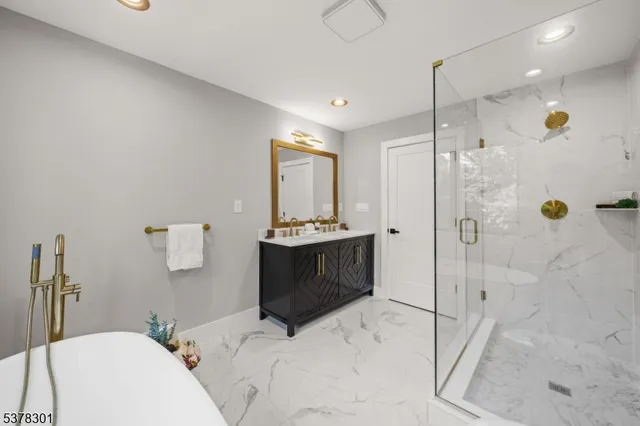 a bathroom with a bathtub shower sink and toilet