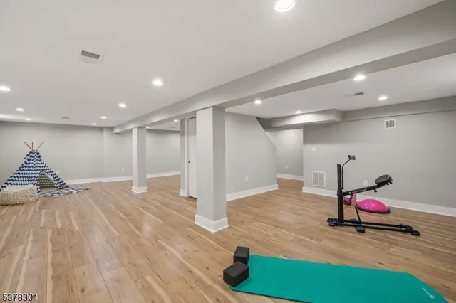 a view of room with wooden floor and furniture