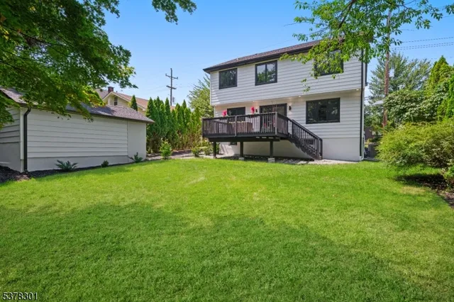 a view of a house with a backyard