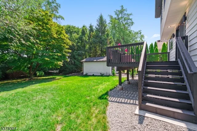 a view of a back yard with a bench