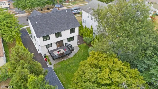 an aerial view of a house with garden space and trees