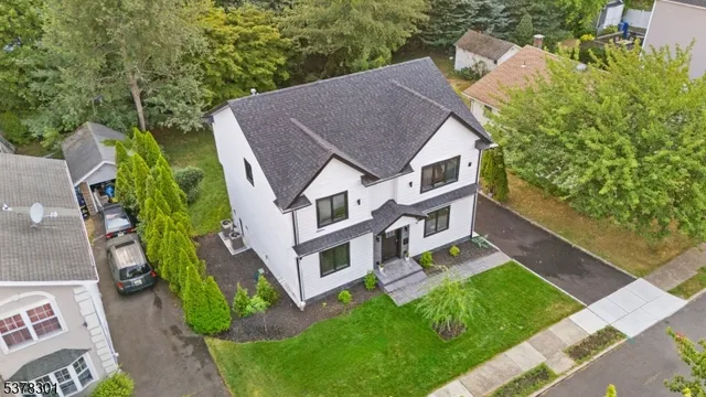 an aerial view of a house with a yard table and chairs