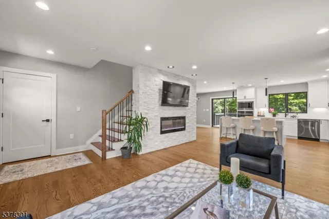 a living room with furniture wooden floor and a fireplace