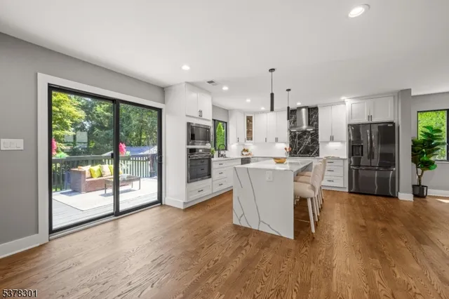 a view of a kitchen with furniture and wooden floor