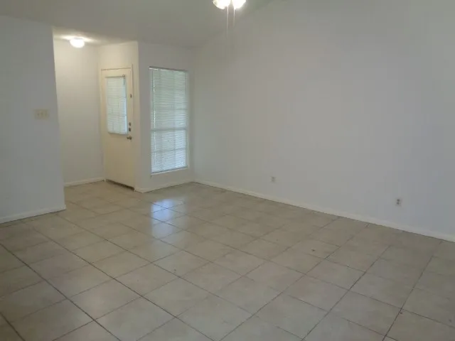 an empty room with entrance and shower