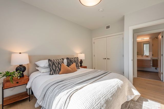 a bedroom with a bed and a lamp