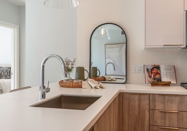 a kitchen with sink and a large window