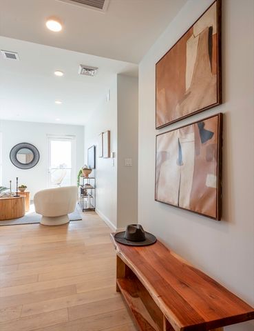 a bedroom with furniture and a painting on the wall