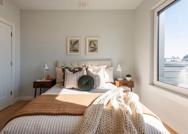 a bed sitting in a bedroom next to a window