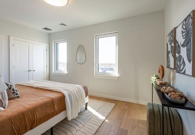 a bedroom with a bed and a window