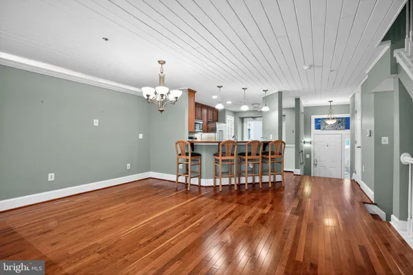 a dining room with furniture and wooden floor