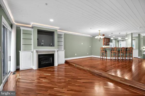 a view of livingroom with kitchen and fireplace