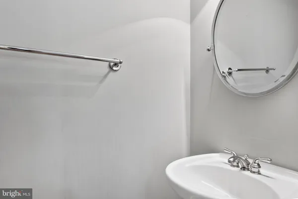 a bathroom with a sink a shower and a mirror