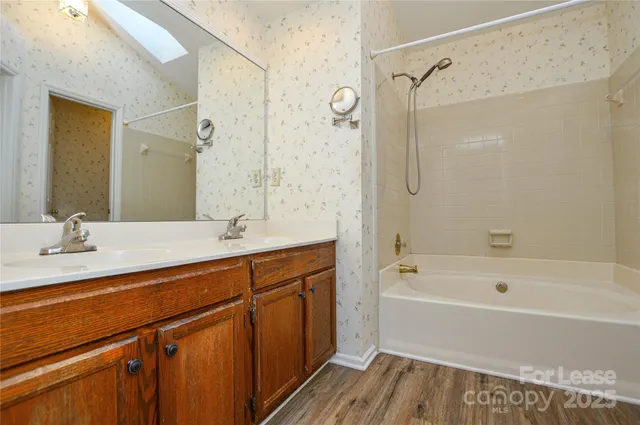 a bathroom with a double vanity sink and mirror