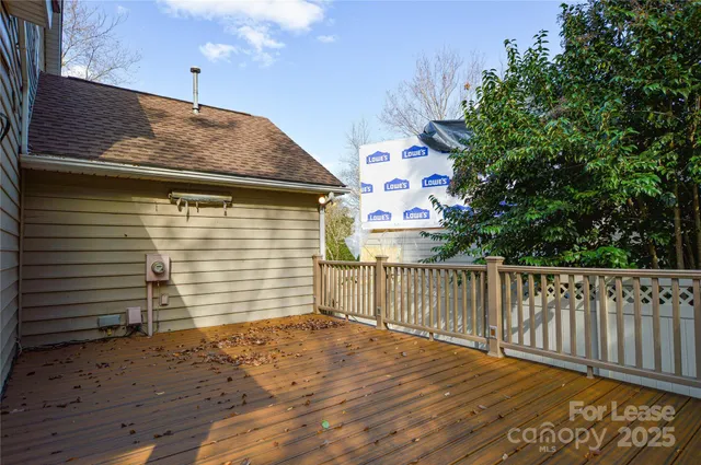a view of a big room with wooden floor and windows